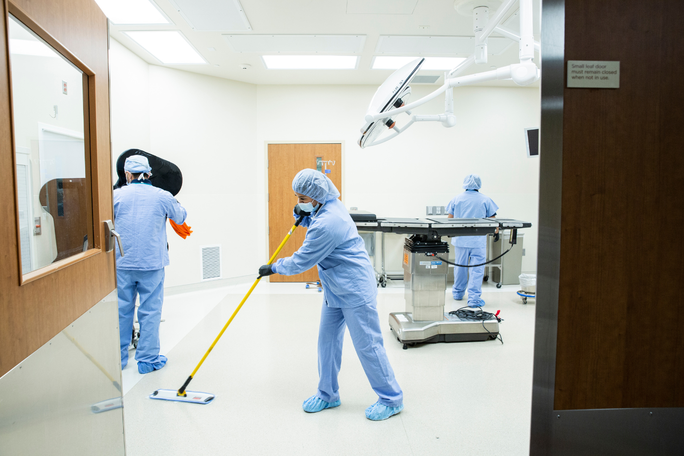 Robotic floor scrubber cleaning hospital hallway in Salt Lake City healthcare facility with KleenMark medical cleaning team.