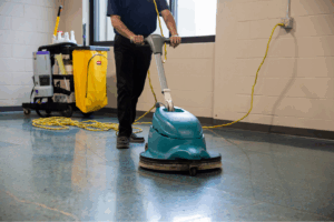 KleenMark technicians performing high surface dusting in a Green Bay manufacturing facility to maintain compliance and safety.